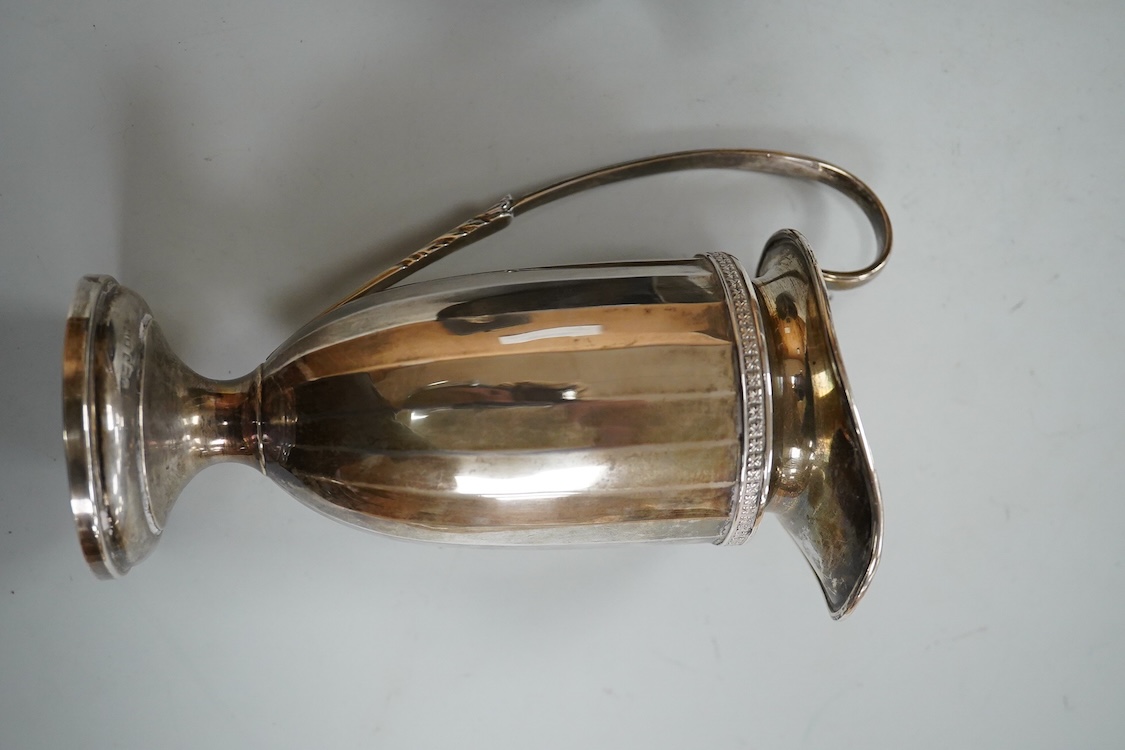 A George V silver tall cream jug, Birmingham, 1930, 17.2cm, a 1950's silver small mug, London, 1955 and a cased 1930's silver three piece condiment set.